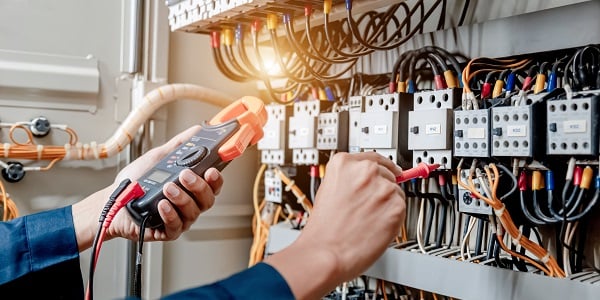 Using a volt meter to measure components in a cabinet