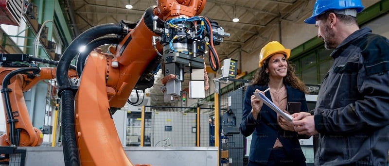 Engineers working with a robot